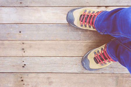 Feet. First-Person view  on rustic wood Floor background.