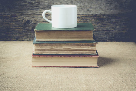books  with coffe cup on retro background の写真素材