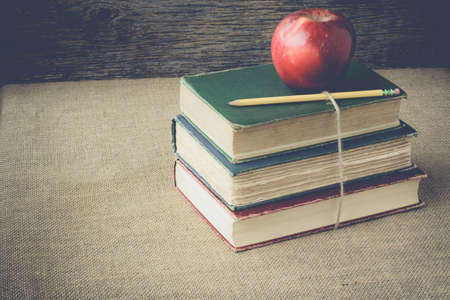 books and apple  on retro backgroundの写真素材