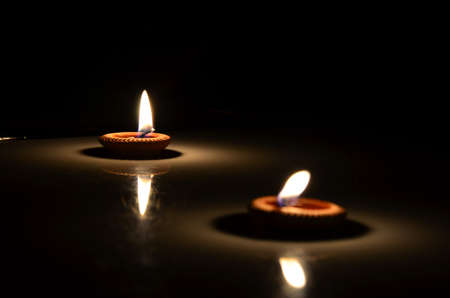 two candles in darkness room. の写真素材