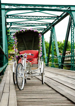 Tricycle thai style on Bridge over Pai River at Pai at Mae Hong Son Thailandの写真素材