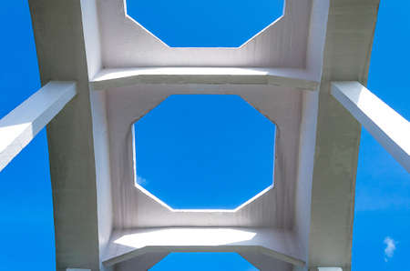 Old white railway bridge constructed against a blue sky in Lamphun, Thailand 