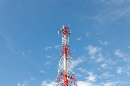 Mobile phone communication antenna tower with the blue sky and clouds