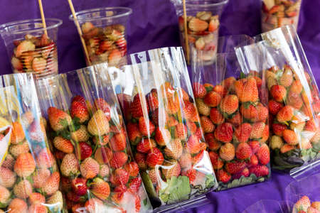 fresh strawberries in plastic packetsの写真素材