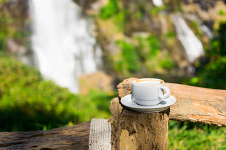 coffee cup with waterfall backgroundの写真素材
