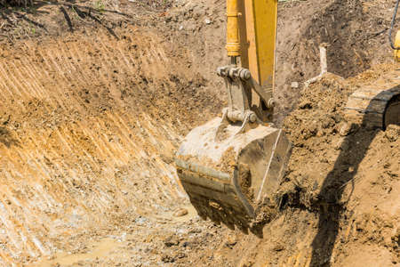 Excavator working at construction siteの写真素材