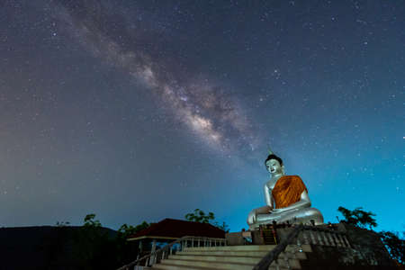 Buddha statue on the milky way background in Thailandの写真素材
