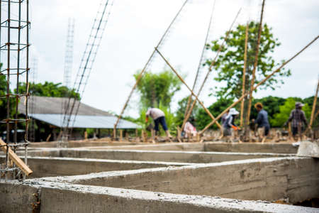 Workers pouring cement as a foundation for a new buildingsの写真素材