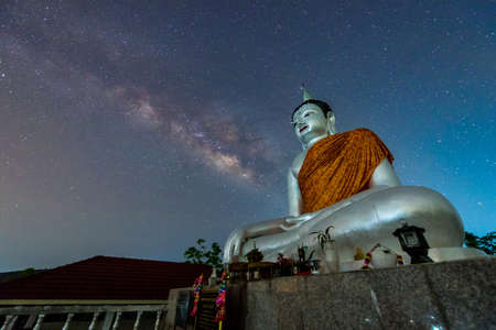 Buddha statue on the milky way background in Thailandの写真素材