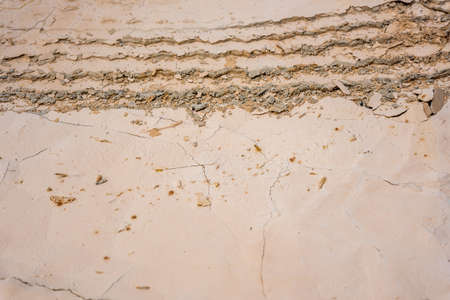Wheel track on dried cracked soilの写真素材