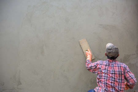 Builder worker plastering  concrete at wallの写真素材