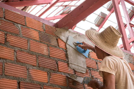 Builder worker plastering  concrete at wallの写真素材