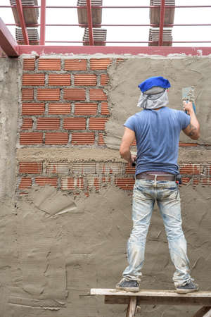Builder worker plastering  concrete at wallの写真素材