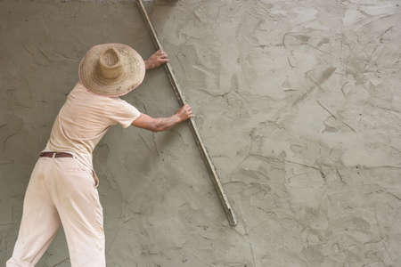 Builder worker plastering  concrete at wallの写真素材