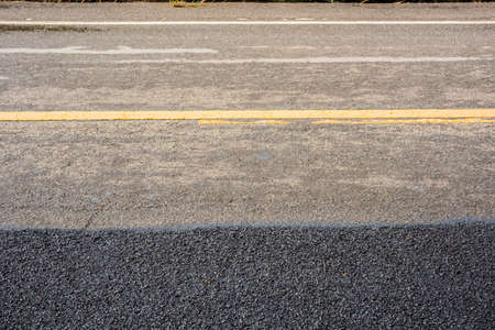 new and old asphalt  of a roadの写真素材