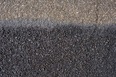 new and old asphalt  of a roadの写真素材