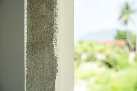 Builder worker plastering  concrete and color paint at wall