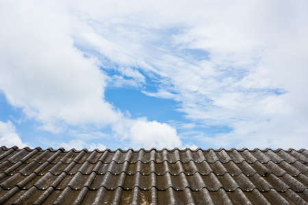 sky and clouds with old and dirty grey roof.の写真素材