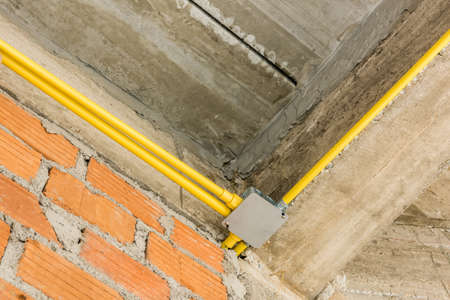 Electric wires installation and pipes of electricity in new house construction site.