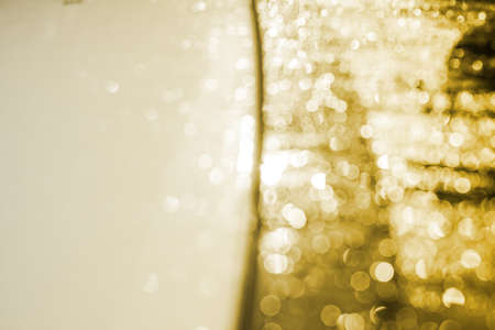gold bokeh of dew on the glassの写真素材