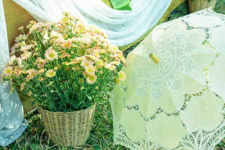 flowers in basket and Lace umbrella wedding accessory (vintage style)の写真素材