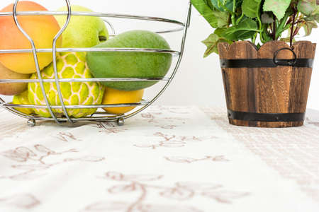 Artificial rose bouquet and Artificial fruit in basketの写真素材