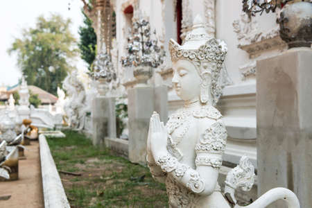 statue of Mythical female bird with a human head at Wat Rong Khun,Thailand.の写真素材