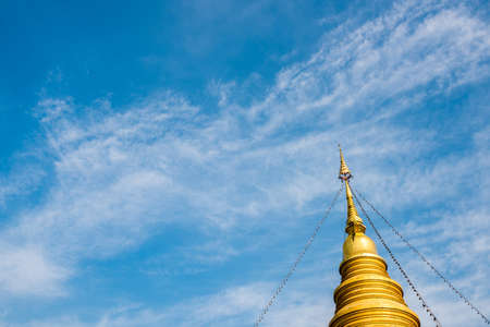 gold pagoda temple with clear blue sky backgroundの写真素材