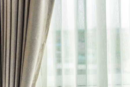 Light shines through curtains in roomの写真素材