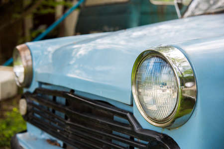 Old car with close-up on headlightsの写真素材