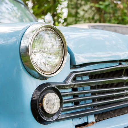 Old car with close-up on headlightsの写真素材