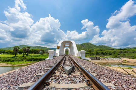 Old white railway bridge constructed against blue sky at Lamphun, Thailand.の写真素材