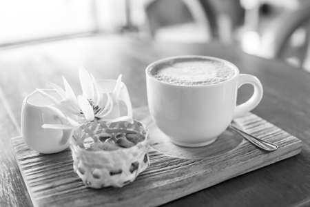 black and white of A cappuccino and some biscuits on the tableの写真素材