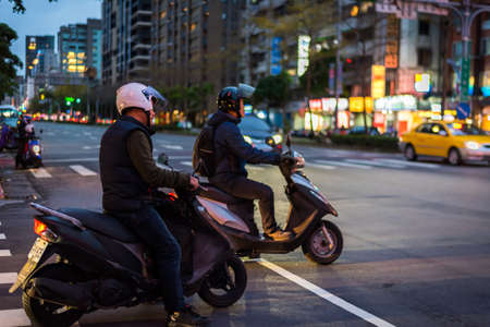 Taipei, Taiwan - April 1, 2017: Taipei Street in one of suburb, district. Scooters Crossing the Street.のeditorial素材