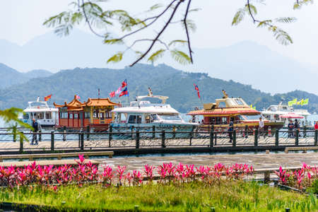 NANTOU, TAIWAN - MARCH 28 : Many tourist people take a trip by boats at the lake of famous attraction, Sun Moon Lake at Taiwan on March 28, 2017 in Nantou county, Taiwan, Asia.のeditorial素材