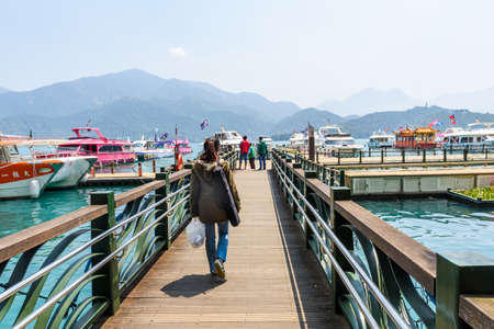 NANTOU, TAIWAN - MARCH 28 : Many tourist people take a trip by boats at the lake of famous attraction, Sun Moon Lake at Taiwan on March 28, 2017 in Nantou county, Taiwan, Asia.のeditorial素材
