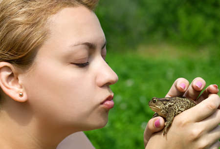 woman kissing a toadの写真素材