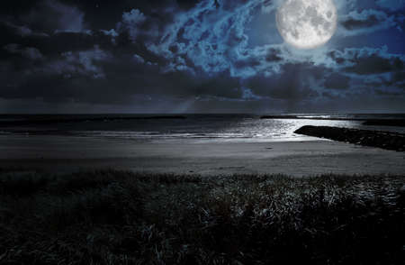 full moon over the oceanの写真素材