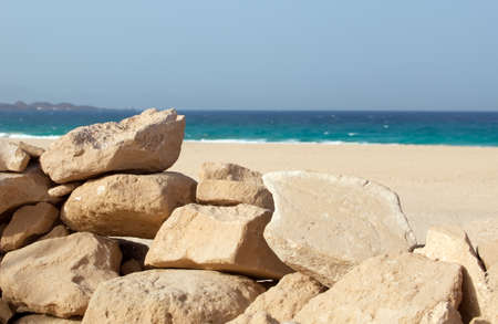 stacked stones and beach in the backgroundの写真素材