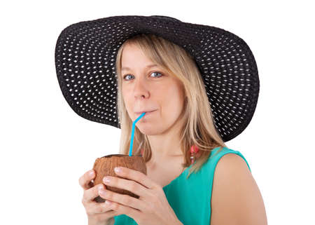 young woman drinking from a coconutの写真素材