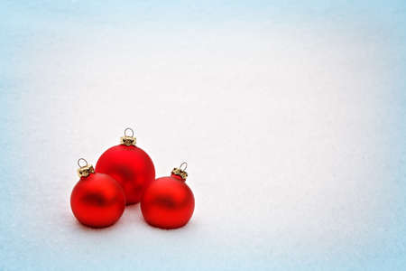 background with three red christmas balls and snowの写真素材
