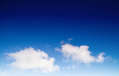bright blue sky with cloudsの写真素材