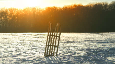 wooden sledge in the snow covered landscapeの写真素材