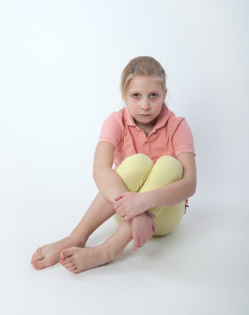 young sad girl sitting on the floorの写真素材