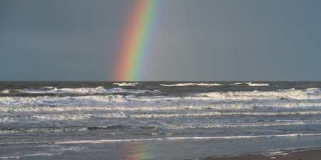 Rainbow over the ocean waterの写真素材