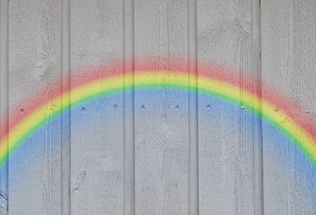 Wooden wall background with a rainbowの写真素材