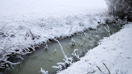 Frozen ditch in the winter landscapeの写真素材