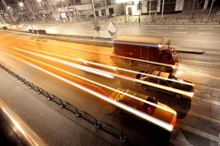 a car and a lorry on the street on the nightの写真素材