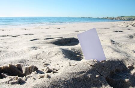 business card inserted in the sandの写真素材