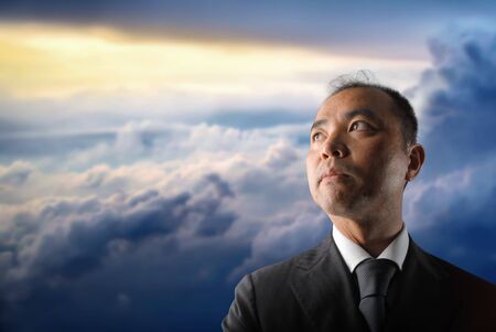 Japanese businessman looking at the skyの写真素材